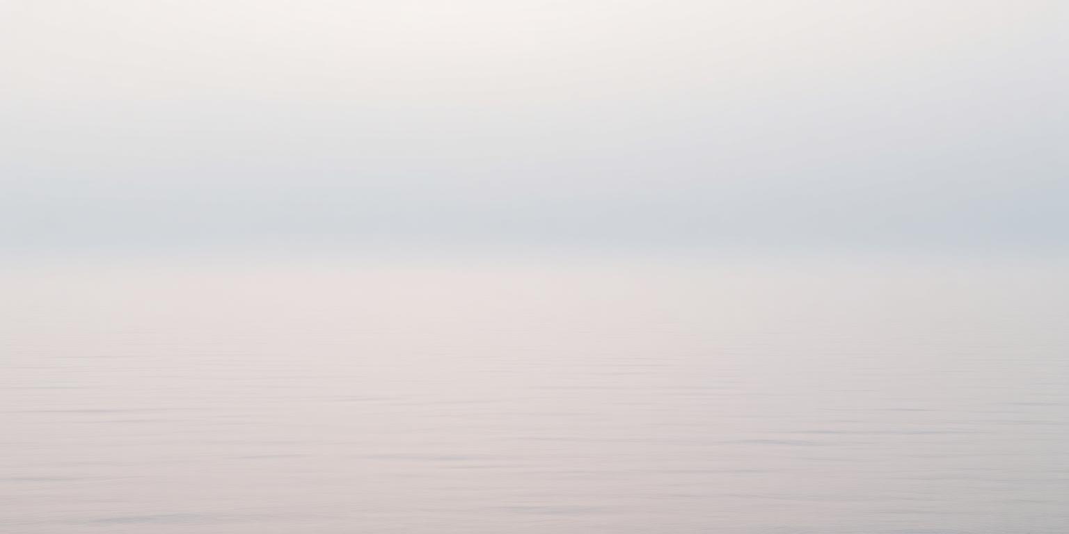 A calm view across the ocean and coastline